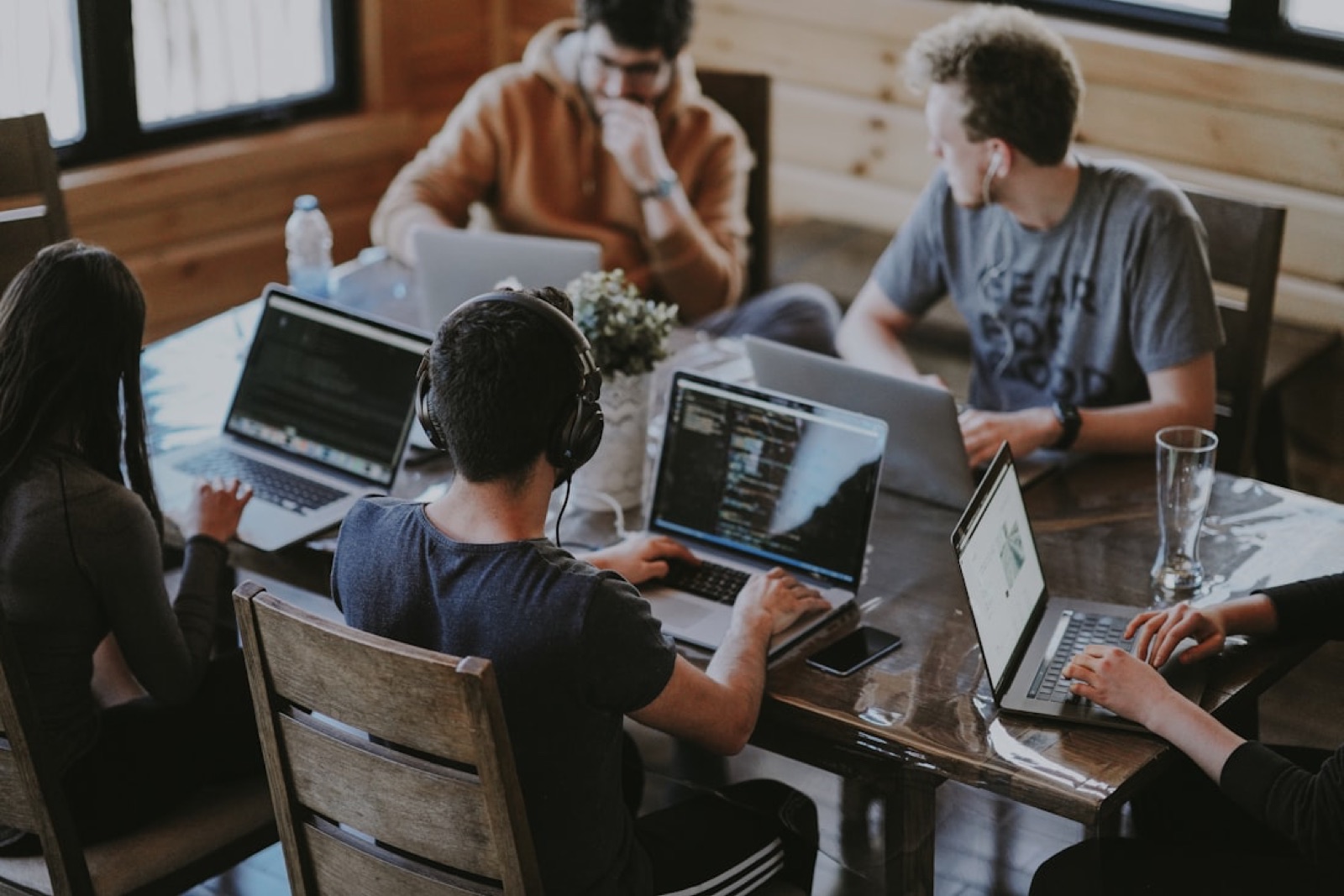 A founding team working at laptops around one table